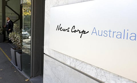 A security guard stands at the entrance to the News Corp. headquarters in Sydney, Thursday, May 28, 2020. (Photo | AP)