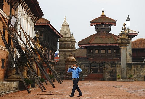 A Nepalese policeman adjusts his face mask as he stands guard in Bhaktapur, Nepal. (Photo | AP)