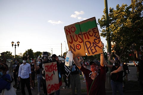 Demonstrators gather Thursday, May 28, 2020, in St. Paul, Minn. Protests over the death of George Floyd, the black man who died in police custody broke out in Minneapolis for a third straight night.