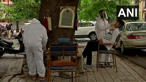 Mohammed Tasin and Mohammed Azam donning PPE kits to attend to their customers in Panchkula. (Photo | ANI)
