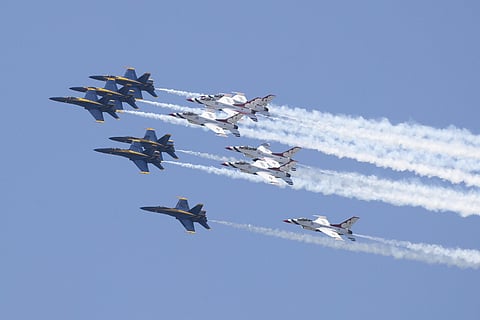 A formation of jets from the Navy's Blue Angels, left, and the Air Force's Thunderbirds fly over Atlanta, to show support for medical workers fighting the coronavirus outbreak. (Photo | PTI)