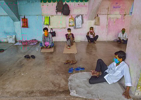 Migrant workers and homeless people rest at a temporary camp set up on the premises of a stadium during ongoing COVID-19 lockdown in Thane. (Photo | PTI)