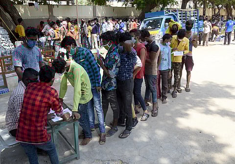 Stranded migrant workers from other states waiting at St Joseph's Anglo Indian Boys Higher Secondary School in Vepery. (Photo | Martin Louis/EPS)