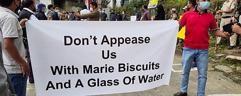 The protesters with a banners that read: 'Don’t appease us with Marie biscuits and a glass of water'. (Photo | EPS)