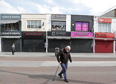 Pedestrians walk along side closed shops during the coronavirus lockdown in London. (File Photo | AP)