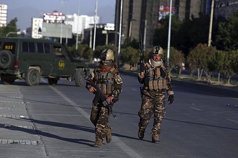 Afghan security forces inspect the site where a bus carrying local TV station employees hit a roadside bomb in Kabul, Afghanistan, Saturday, May 30, 2020. (Photo | AP)