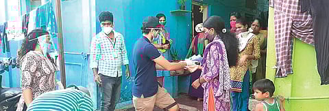 Volunteers distribute sanitary napkins to daily wage and migrant workers. (Photo| EPS)