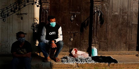 A Nepalese street vendor selling face masks waits for customers. (Photo | AP)