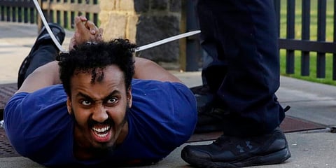 A demonstrator is detained by Atlanta Police after a demonstration turned violent on Saturday. (Photo | AP)