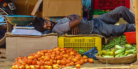 A vendor taking a nap at his vegetable stall during lockdown in Bhubaneswar. (Photo| Biswanath Swain, EPS)