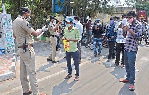 Police collect details of migrant workers at the Sub-Collector office in Vijayawada on Sunday to send them to their hometowns. (Photo| Prasant Madugula, EPS)