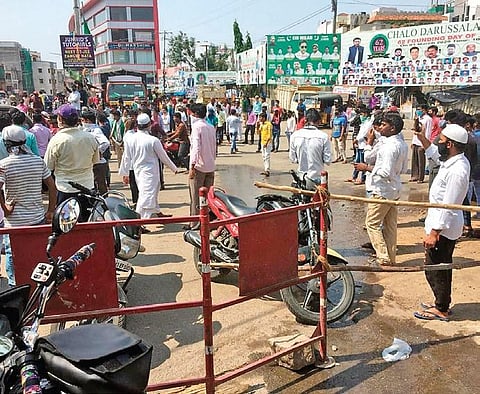 Migrant workers protest at Tolichowki labour adda following the extension of the lockdown, in Hyderabad on Sunday