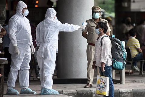 Students who were stranded in Kota due to nationwide lockdown undergo thermal screening after arriving by Delhi Transport Corporation (DTC) buses at Kashmere Gate ISBT in New Delhi on Sunday May 03 2020. (Photo | Parveen Negi/EPS)