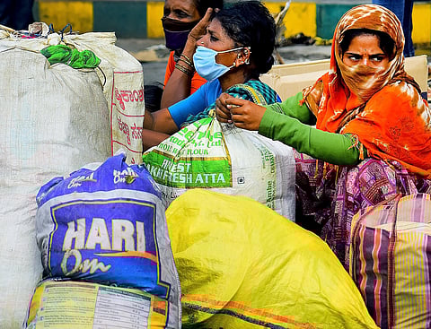 A family taking break sat therpad side in Bengaluru on Sunday. (Photo | Pandarinath B/EPS)