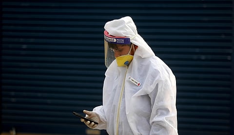 An petrol pump employee wearing personal protective equipment PPE kit at a fuel filling station. (Photo | Shekhar Yadav, EPS)