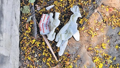 Despite the health risks they pose, used gloves and face masks are being casually thrown away across the city. (Photo  | Debadatta Mallick, Ashwin Prasath/EPS)