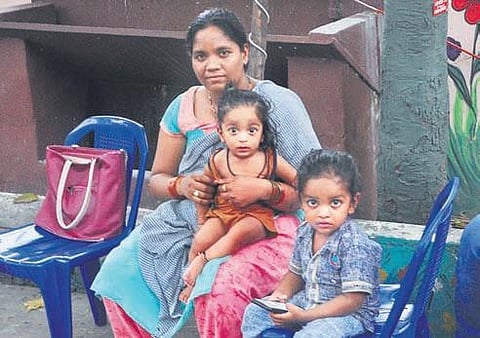 Migrant workers wait to return to their houses, at a GVMC shelter  in Visakhapatnam on Sunday. (Photo| G SatyanarayanaM, EPS)