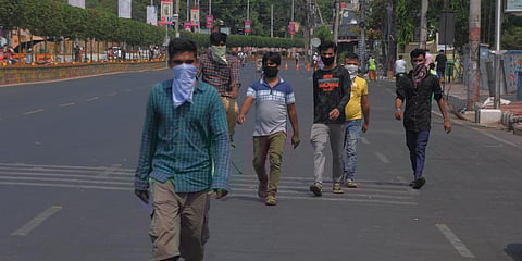 Migrant workers on their way to Sub-Collector office seeking help to return go to their respective hometown during the ongoing lockdown in Vijayawada. (Photo| Prasant Madugala, EPS)
