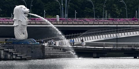 People walk past the Merlion statue at Merlion Park in Singapore. (Photo| AFP)