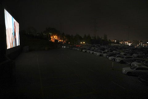 People sit in their cars watching a movie at a new drive-in cinema on a car parking area of the Milad telecommunications tower, as regular theaters are closed due to the coronavirus outbreak, Friday, May 1, 2020. (Photo | AP)