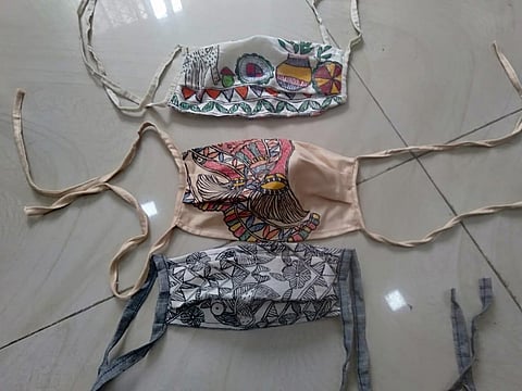 The masks imprinted with Madhubani paintings