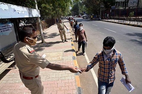 Migrants maintain social distance while submitting forms to travel to their native places during the ongoing COVID-19 nationwide lockdown at Vashi in Navi Mumbai Tuesday. (Photo | PTI)