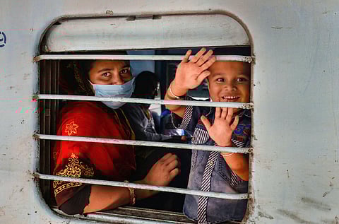 Migrant workers wave as they board a train to their native places during the ongoing COVID-19 nationwide lockdown. (File Photo | PTI)| Image for representation