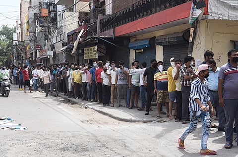 People stand in a queue outside a wine shop after authorities allowed sale of liquor with certain restrictions during the ongoing COVID-19 nationwide lockdown. (Photo | Parveen Negi, EPS)
