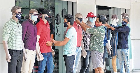 Textile shop workers putting on designer face masks on mannequins in Kochi. While masks and gloves have become common since the Covid-19 outbreak, some have taken the protective gear to the next level by giving them a stylish twist | A Sanesh