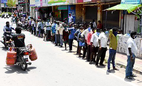 Heavy crowd at Liquor shops as the government allowed to open liquor shops today police men observing the people and told them to maintain social distance in tirupati on Monday. (Photo | Madhav K/EPS)
