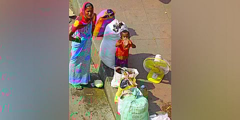 A migrant worker’s family waits to board a bus in Bengaluru | Pandarinath B