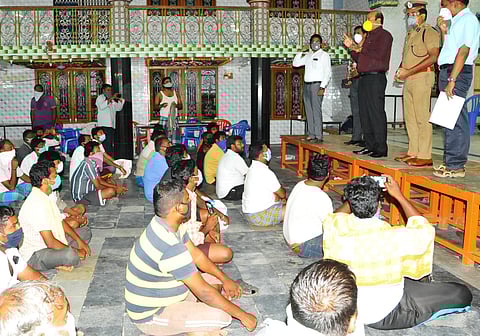 Vellore district collector A Shanmuga Sundaram interacting with the stranded vehicle crew who returned after dropping CMC patients (Photo by special arrangement)