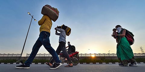 Migrant workers along with their family members walk along the Delhi-UP border road during the ongoing COVID-19 nationwide lockdown, in East Delhi. (File photo| PTI)