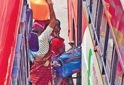 Migrant workers board a BMTC bus in Bengaluru on Tuesday | PANDARINATH B
