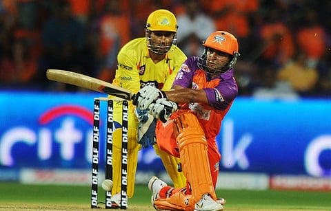 Parthiv Patel is watched by Chennai Super Kings wicketkeeper Mahendra Singh Dhoni. (Photo | AFP)