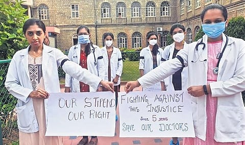 Resident doctors hold a protest at Victoria Hospital in Bengaluru