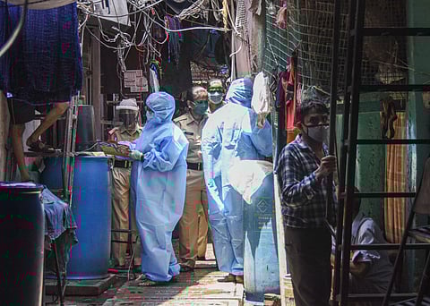 Health workers wearing protective suits screen the residents of Naik Nagar during a house-to-house health survey after detection of some COVID-19 positive cases during the nationwide lockdown at Dharavi in Mumbai Wednesday May 6 2020. (Photo | PTI)