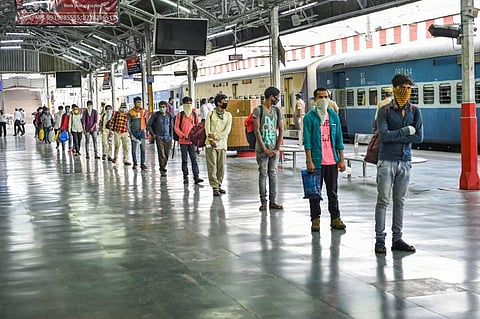 Migrants who arrived from Maharashtra by a special train follow social distancing after deboarding at Charbagh railway station during the ongoing COVID-19 lockdown in Lucknow. (Photo | PTI)