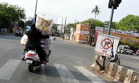 A women try holding big bags of eatables going on a scooter during lockdown in Hyderabad on Thursday. (Photo | EPS/R V K Rao)