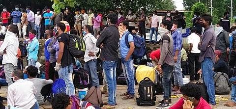 Migrant workers gather at the central railway station in Mangaluru. (Photo| EPS)