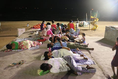 People who moved out of their homes in Gopalapatnam, Madhavadhara and Kancharapalem areas sleeping on beach road in Visakhapatnam. (Photo | EPS)