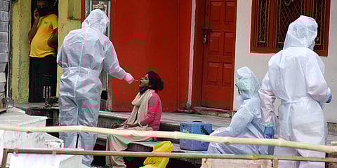 A medical team collects a swab sample of a COVID-19 suspect. (Photo| ANI)