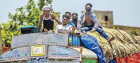 Migrant workers travelling on a truck in Bhubaneswar. | Express