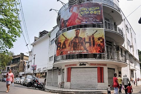 A person walks past a cinema hall in Kolkata. (Photo| PTI)