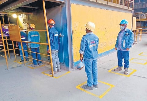 Jindal South West Steel Plant Limited employees maintain social distance before entering the premises, in Ballari district | EXPRESS