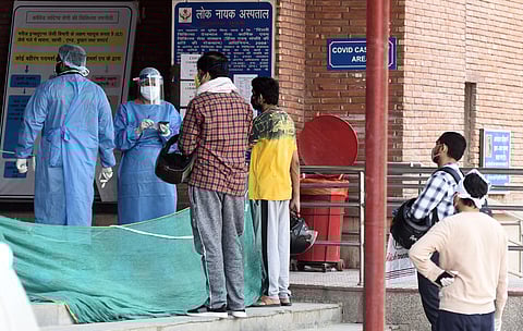 Medical workers in PPE gear interacting with visitors outside the COVID-19 ward at Lok Nayak Jai Prakash Narayan Hospital LNJP on June 10 2020 in New Delhi. (Photo | Parveen Negi/EPS)