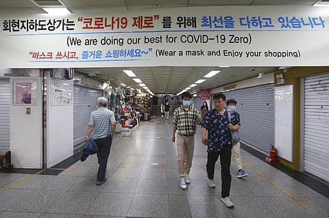 People walk through an underground shopping mall in Seoul, South Korea. (Photo | AP)