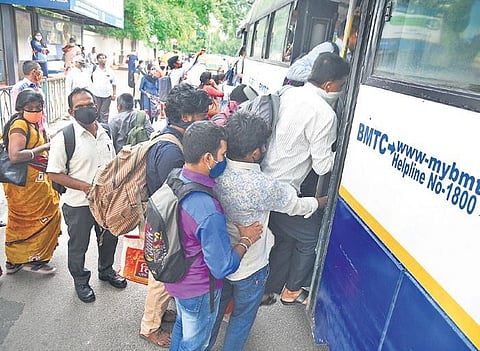Commuters rush into a BMTC bus without maintaining social distancing at the a bus stop on Ambedkar Veedhi Road in Bengaluru on Thursday | Nagaraja Gadekal