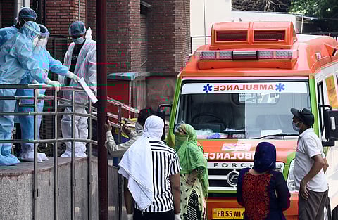 Medical workers in PPE gear interacting with visitors outside the Covid-19 ward at Lok Nayak Jai Prakash Narayan Hospital LNJP on June 12 2020 in New Delhi. (Photo | Parveen Negi/EPS)