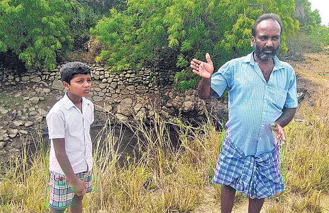 Ramesh, farmer from Malaipalayam, near a contaminated irrigation well. He says  he quit farming and now works as a cable TV operator (Photo | EPS)
